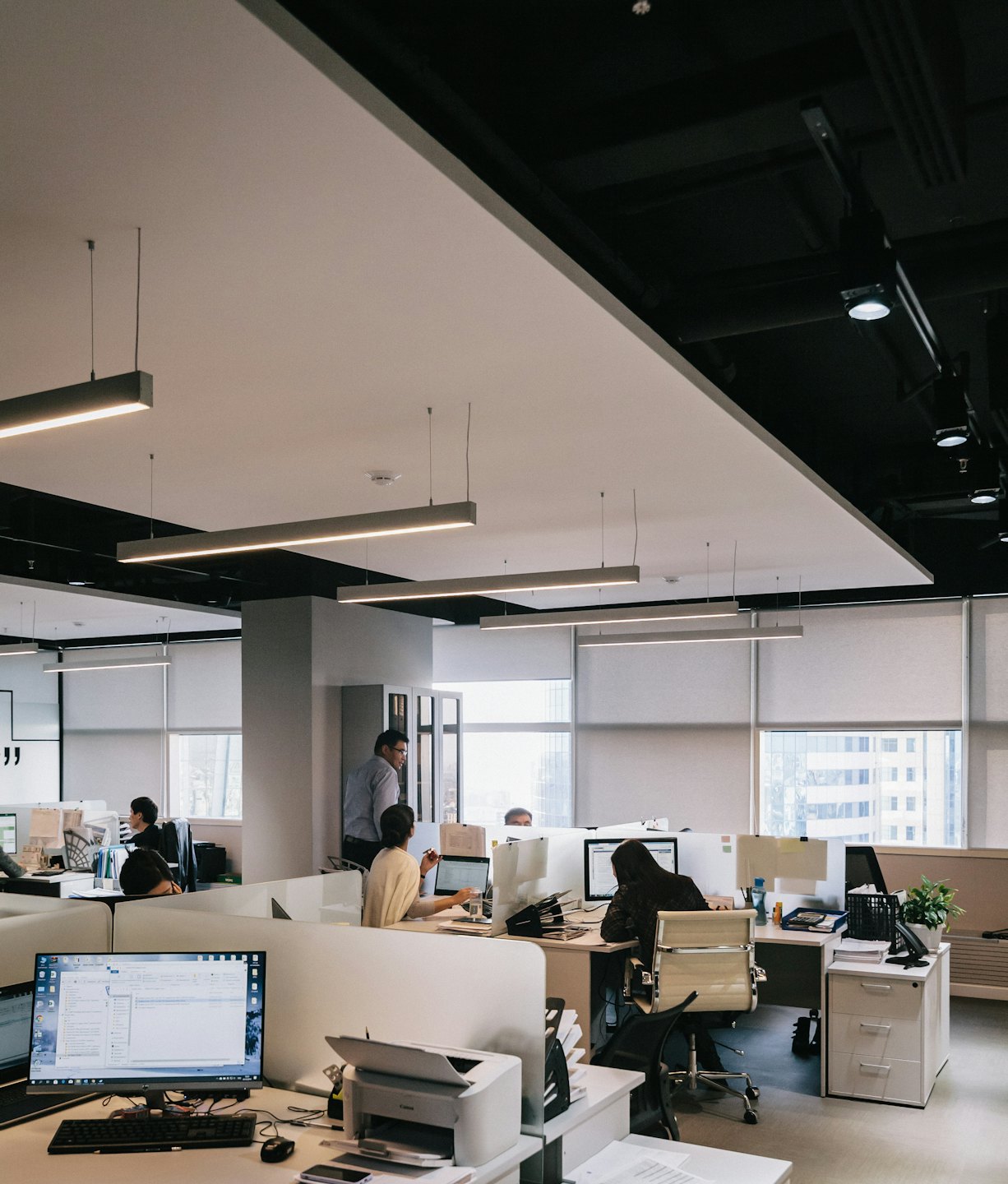 Diverse team members collaborating in a modern open-plan office.