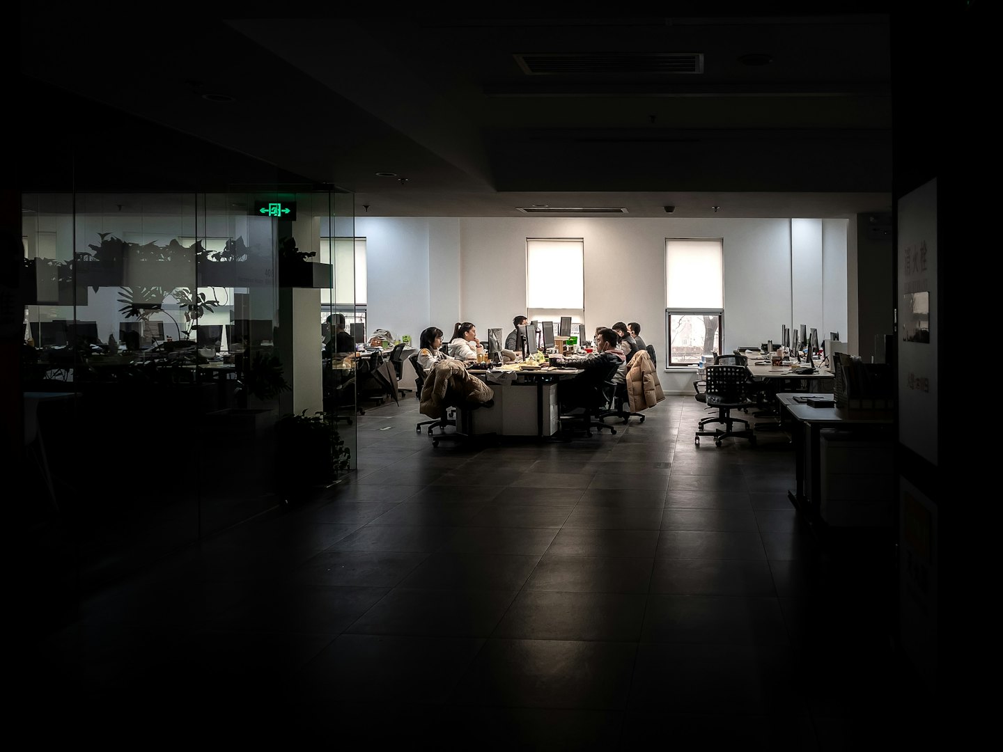 Team collaborates at desks in a modern office.
